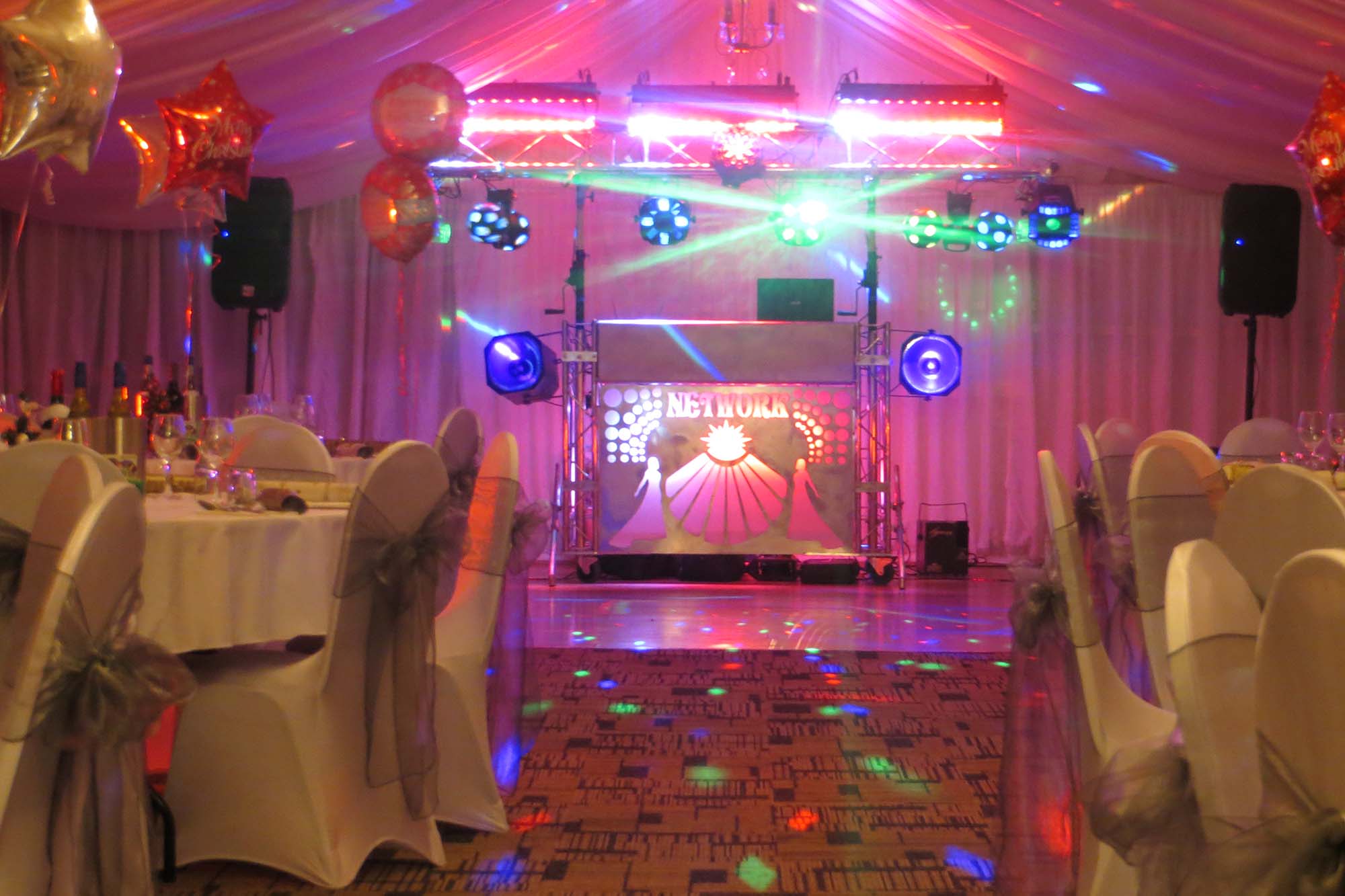 Mobile Disco Network DJ booth and light show set up in a decorated function room