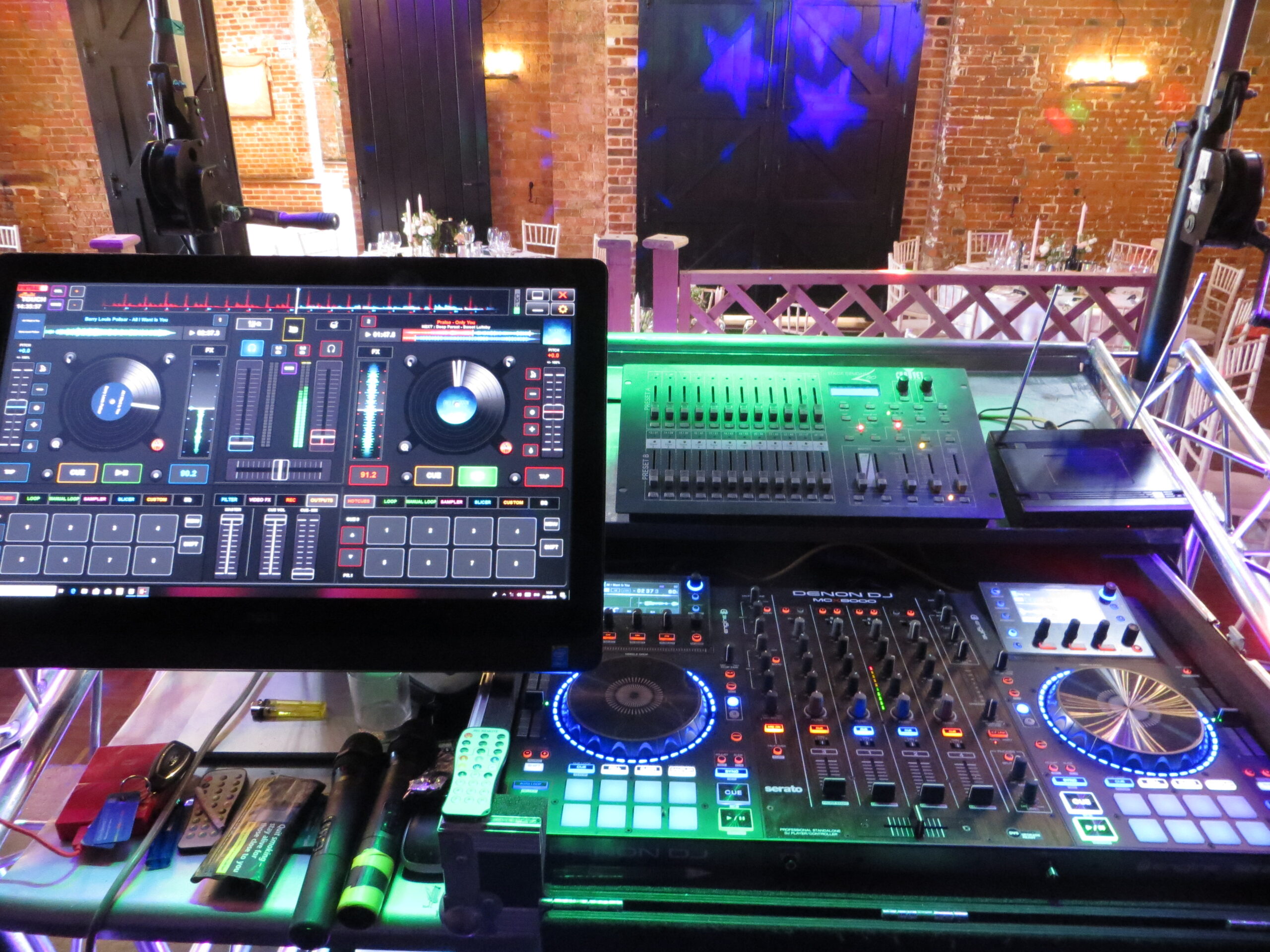 Tim’s DJ booth set up at an event with LED lighting and speakers on stands