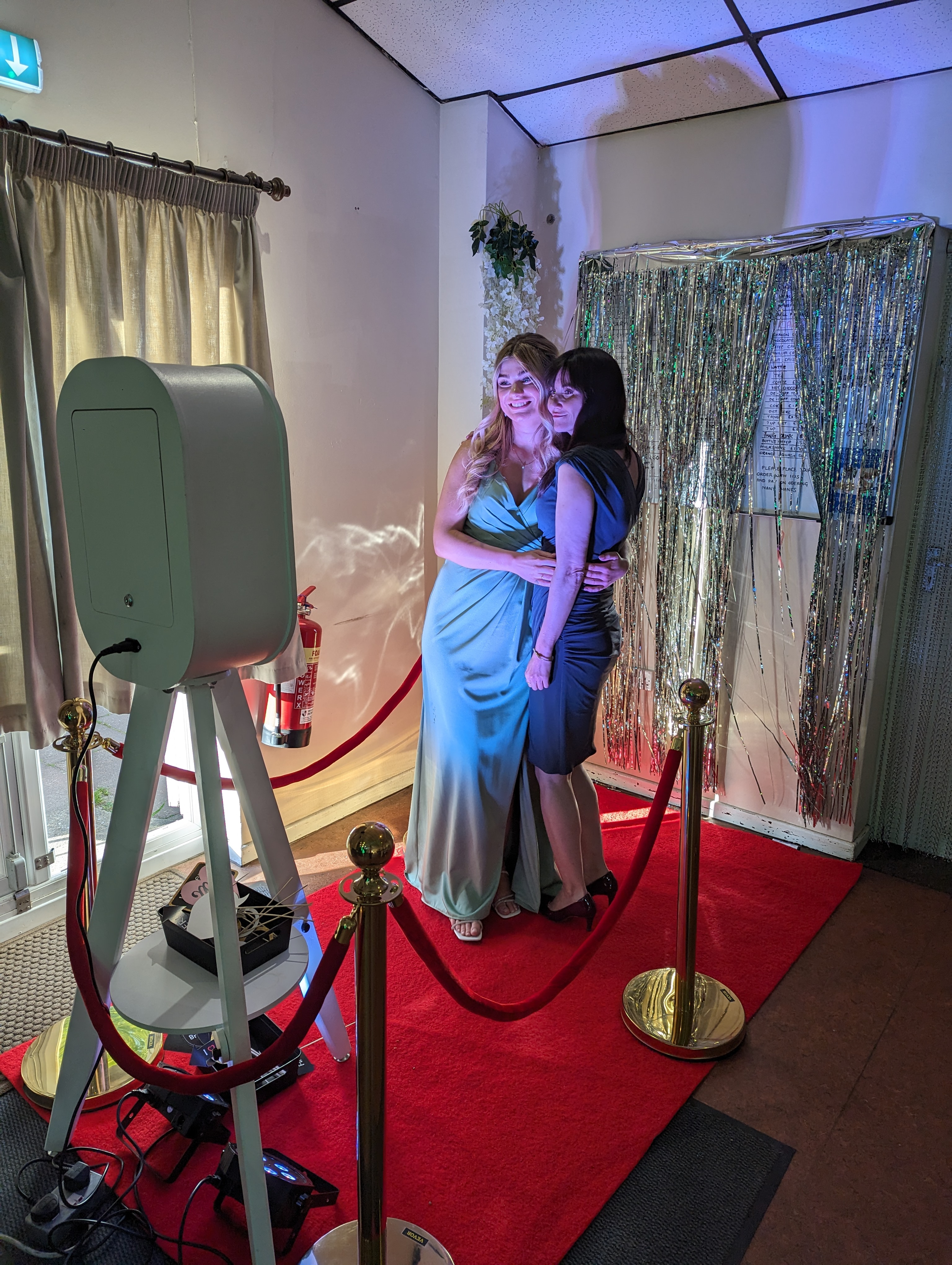 Wedding guests posing together in front of the white vintage selfie pod