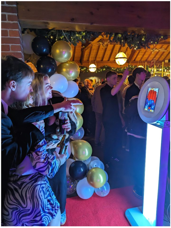Guests posing at the ring light selfie pod during an evening party at Dunston Hall