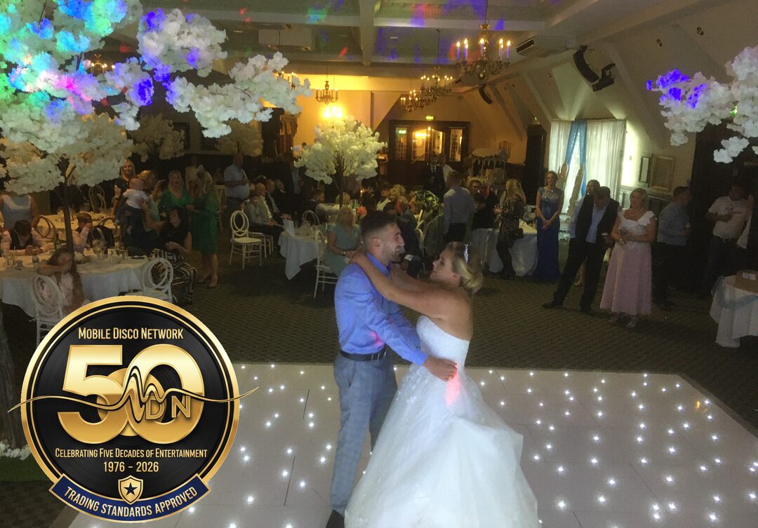 Couple sharing a first dance on a white starlit dance floor at Dunston Hall near Norwich