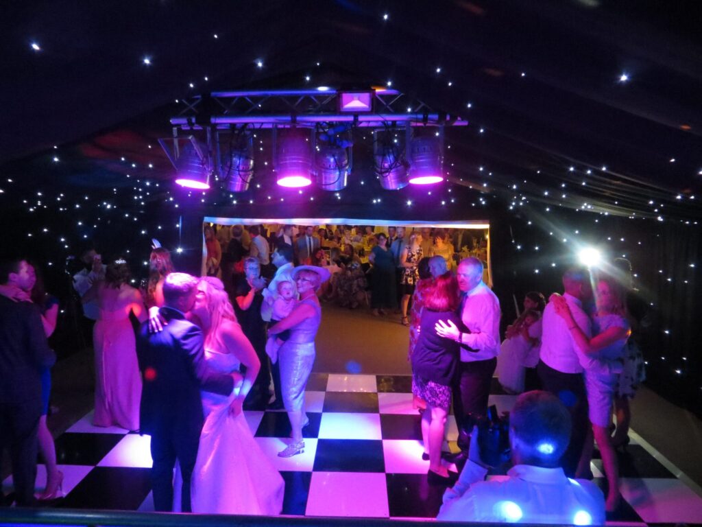 Tinsel Tim DJing at a Cambridgeshire wedding with guests on the dance floor